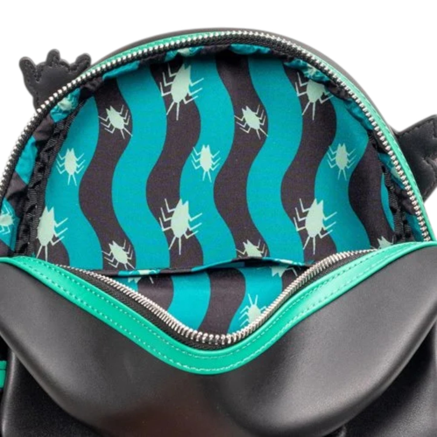 Close-up of a backpack with a beetles pattern on the interior lining.