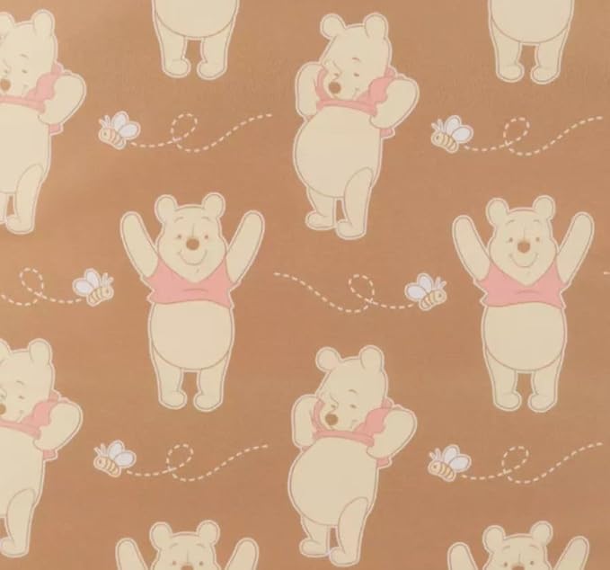 Pattern of cartoon bears with pink bows on a brown background