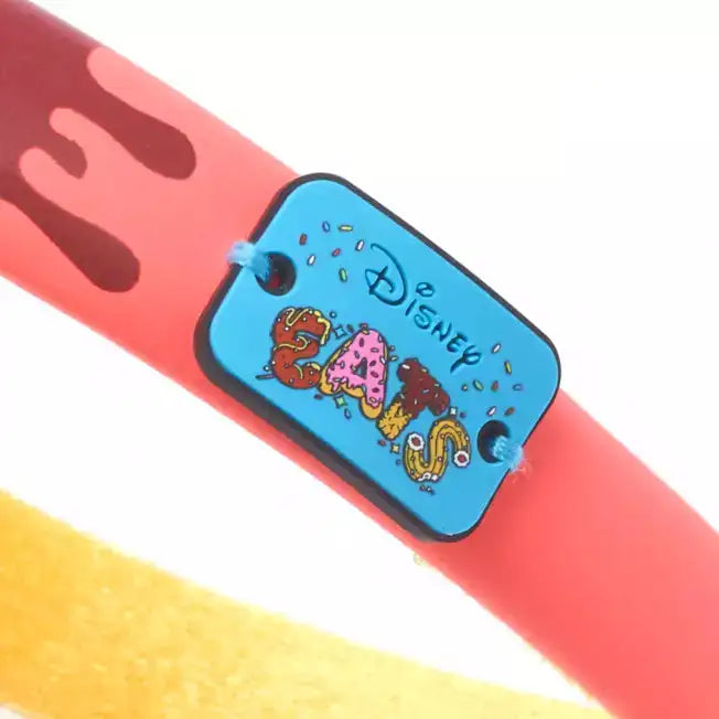 Headband with a blue patch featuring "Disney Eats" on a white background