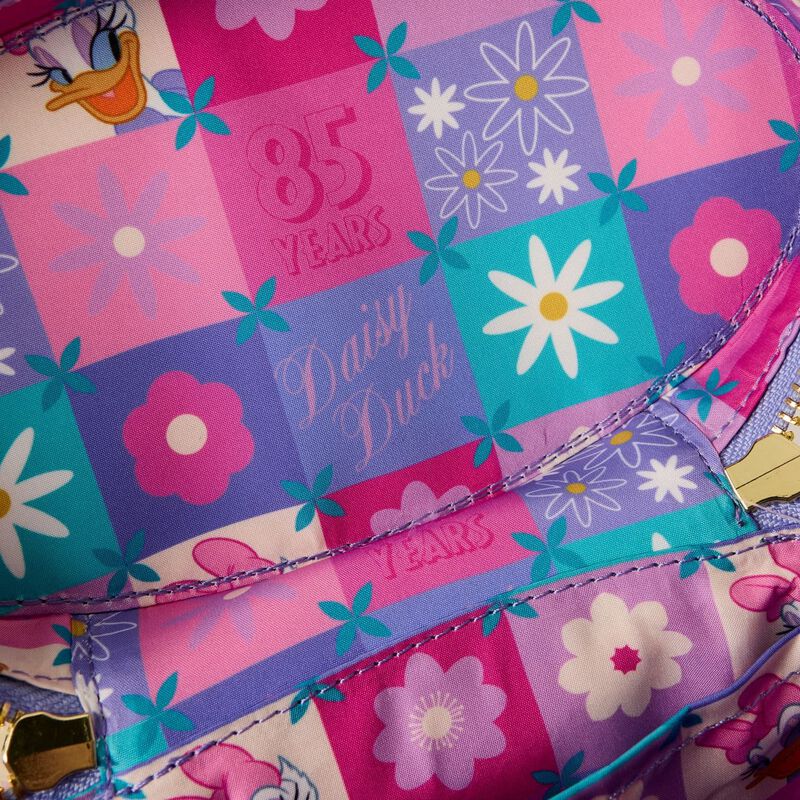 close-up colored pattern with daisy duck character and text "85 Years"
