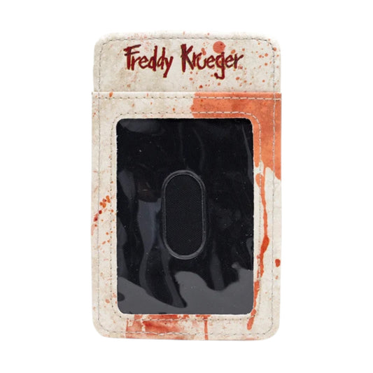 A Freddy Krueger themed credit card holder or wallet with a distressed off-white faux leather exterior, red blood-splatter details, and the 'Freddy Krueger' logo printed at the top, featuring a black plastic ID window in the center.