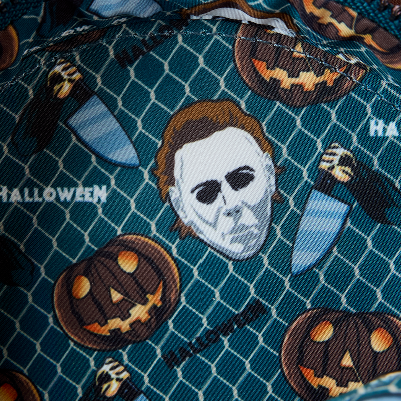 Michael Myers Mask fabric with pumpkins, knives, and a Michael Myers head on a blue grid background.