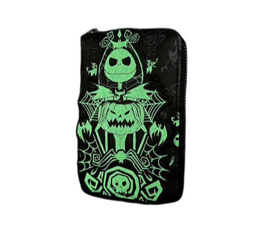 Glowing green jack-o'-lantern design on a black wallet against a white background
