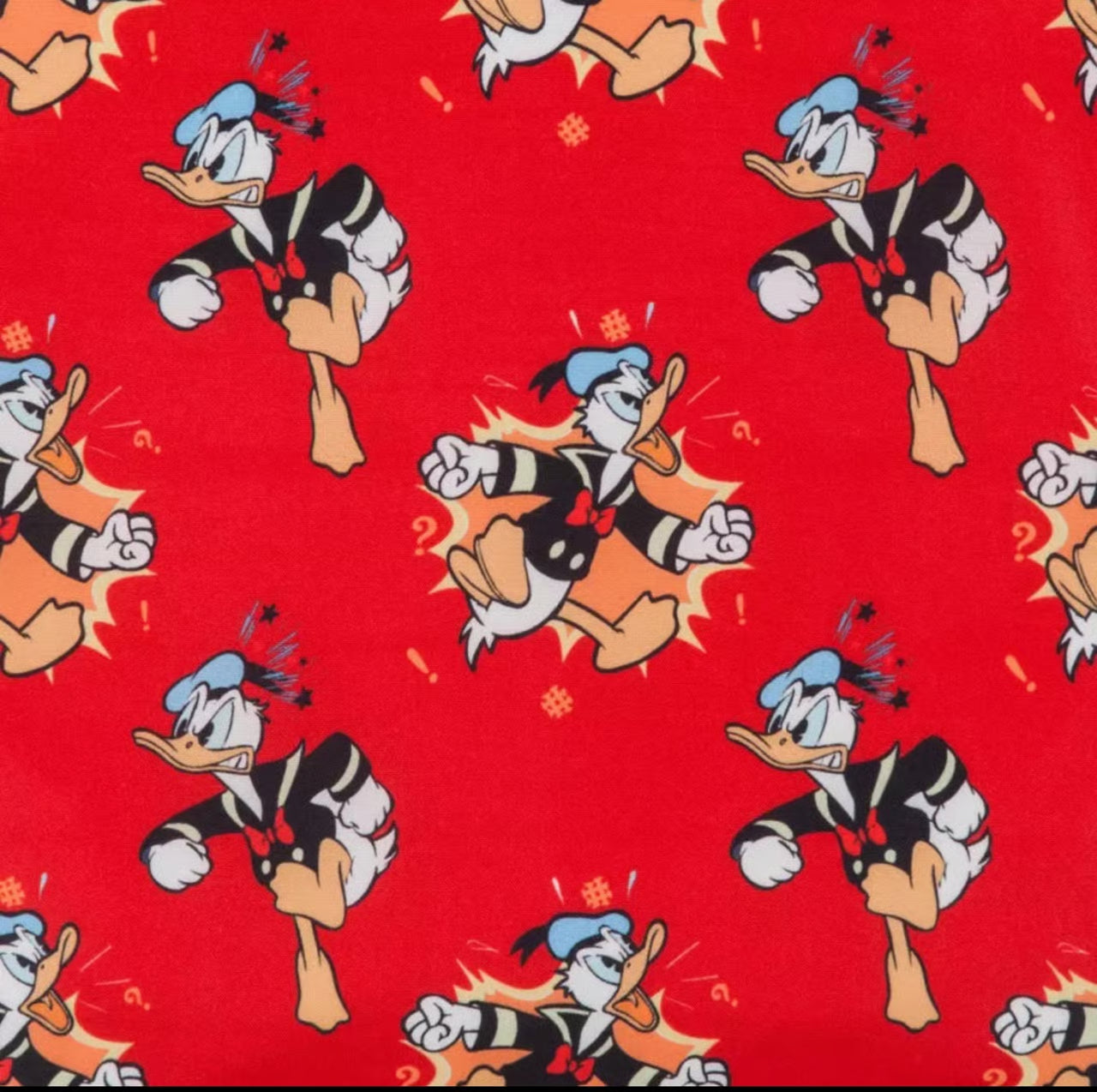 Inside of Loungefly Disney Donald Duck 90th Anniversary Color Changing Mini Backpack with angry Donald Duck character patterns on a red background