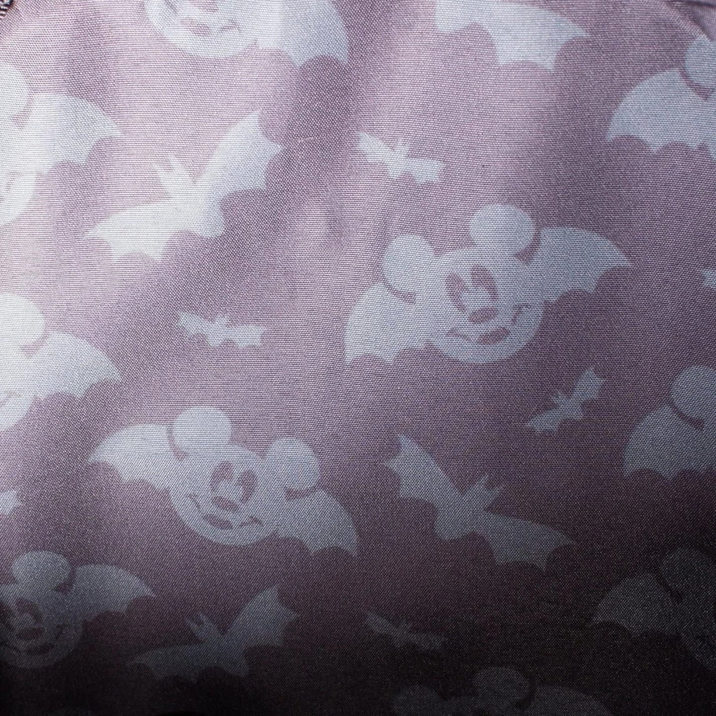 Pattern of mickey mouse head bats on a dark background