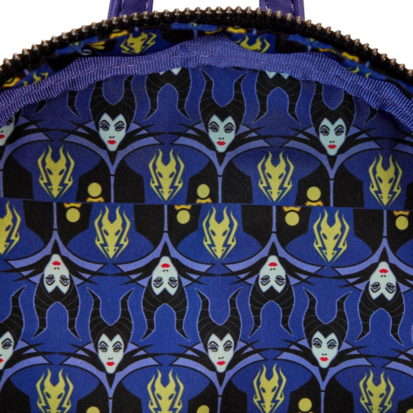 Close-up of Loungefly Disney Maleficent Dragon Lenticular Glow in The Dark Mini Backpack with Maleficent pattern on a blue background
