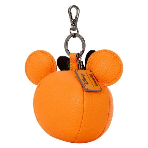 An orange textured leather Mickey Mouse-shaped keychain bag with two round ears, a silver metal clasp, and a Disney tag on a white background.