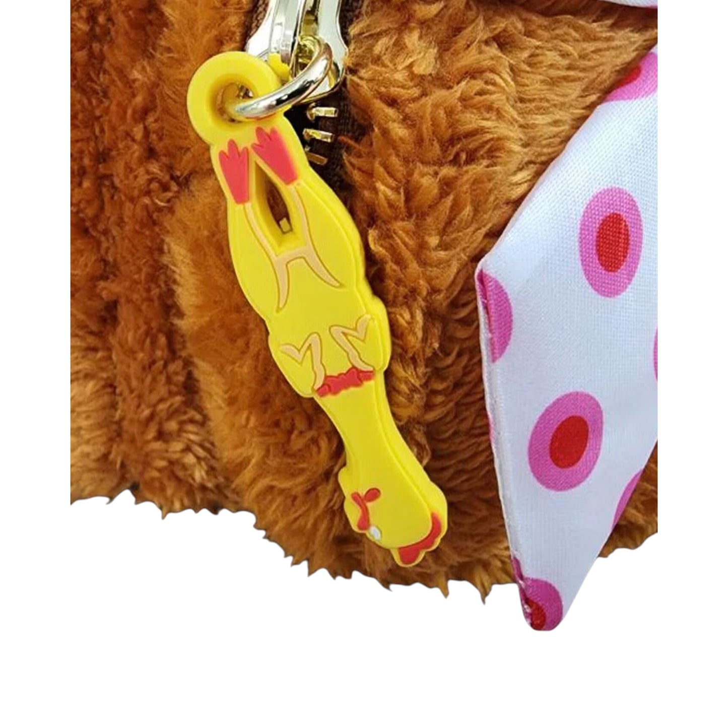 Plush teddy bear with a yellow chicken zipper charm and polka dot fabric on a white background