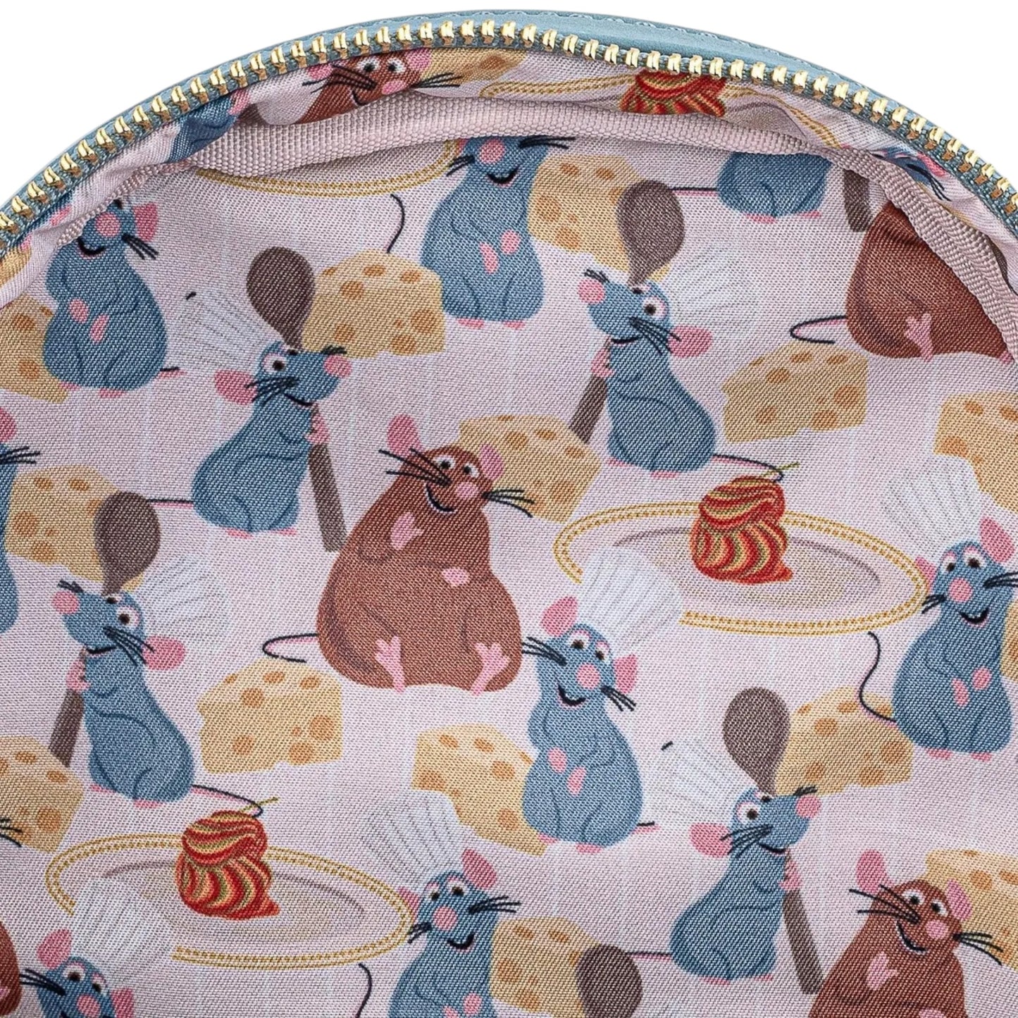 Close-up of inside of Loungefly Disney Pixar Ratatouille Chef Cosplay Mini Backpack with patterned fabric with Ratatouille and cheese characters on a light gray background
