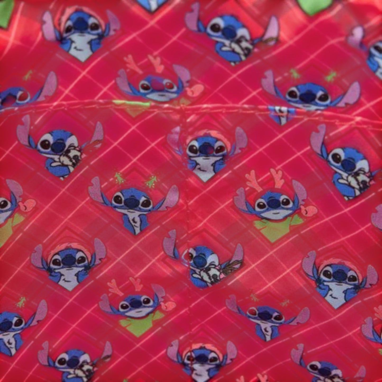 Fabric with stitch character pattern on a red background