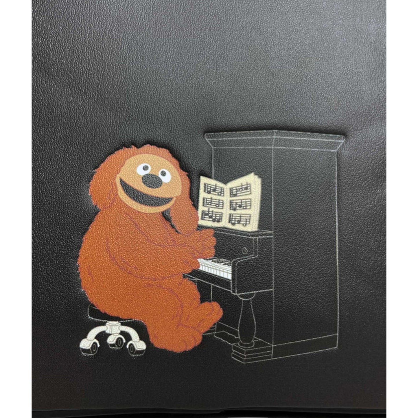 Illustration of Muppets Rowlf playing a piano on a black background