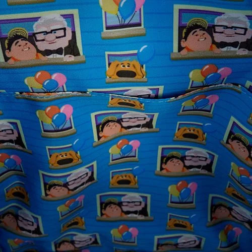 Inside of Loungefly Pixar Up Carl and Russell Mini Backpack with blue fabric with movie character and balloon patterns on a blue background