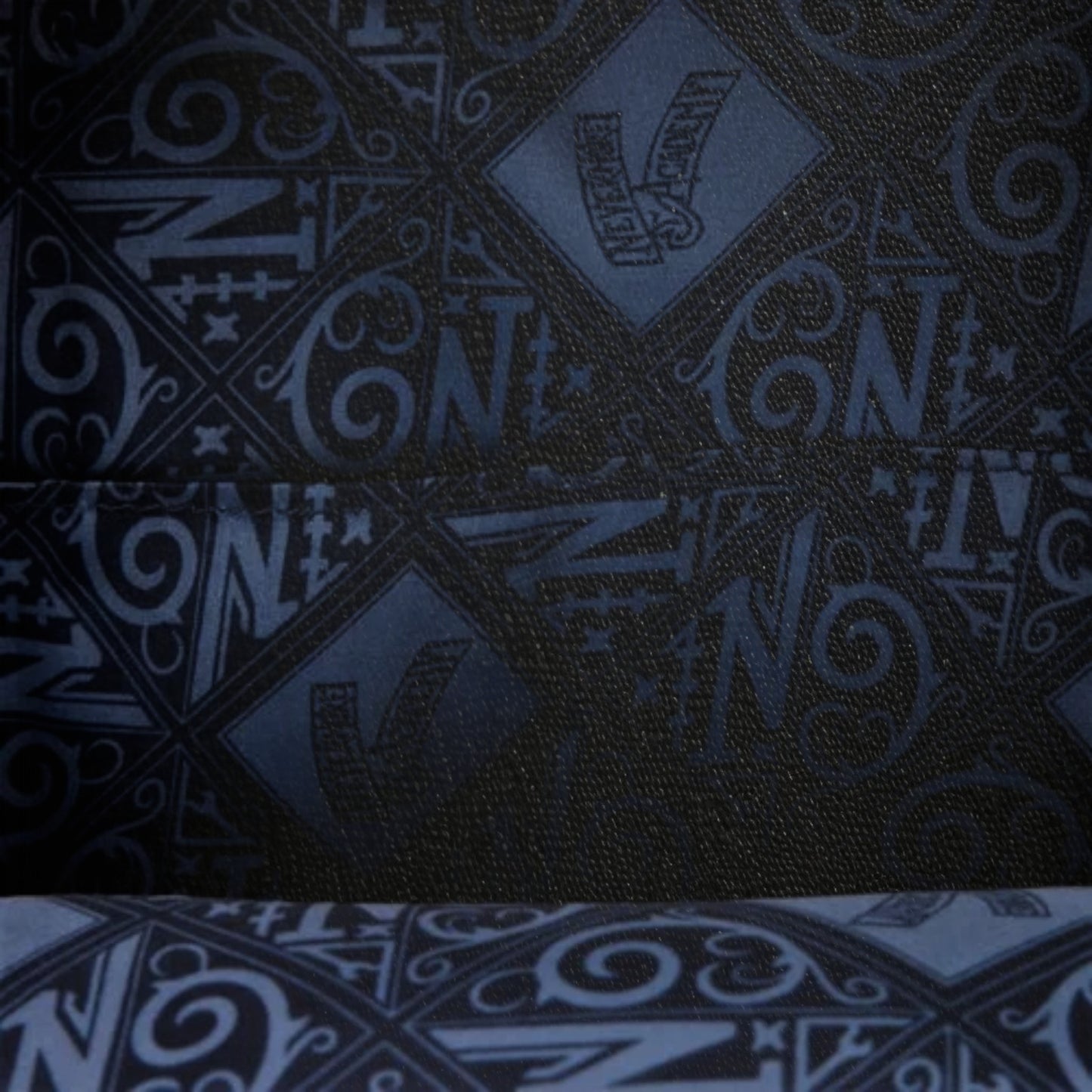 Dark fabric with blue geometric pattern and 'N' text