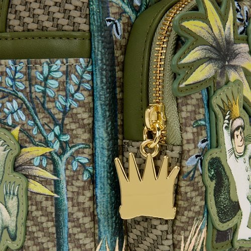 Gold crown charm on a textured fabric background with floral and Where the Wild Things Are character designs.