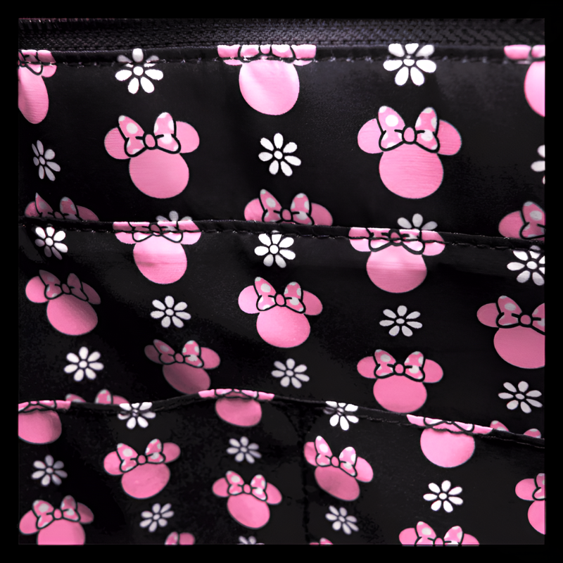 Pattern of pink Minnie Mouse ears and flowers on a black background