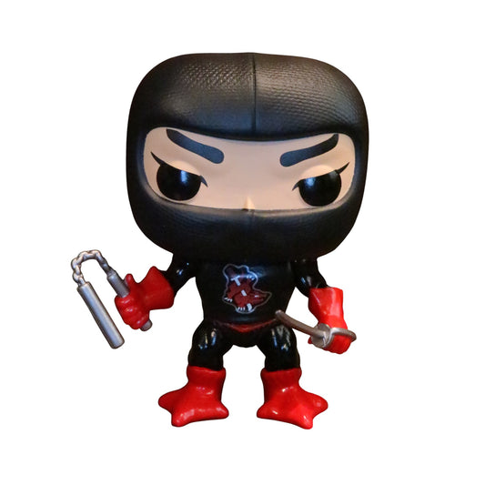 Ninjor figurine with red gloves and black mask holding num-chuks and a sword on a white background