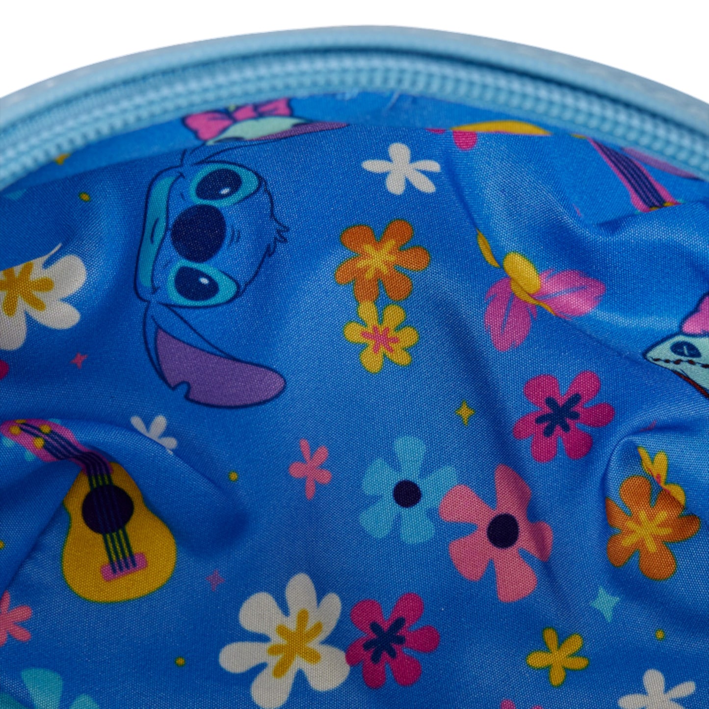 Blue bag with stitch and scrump characters and colorful flowers on a white background