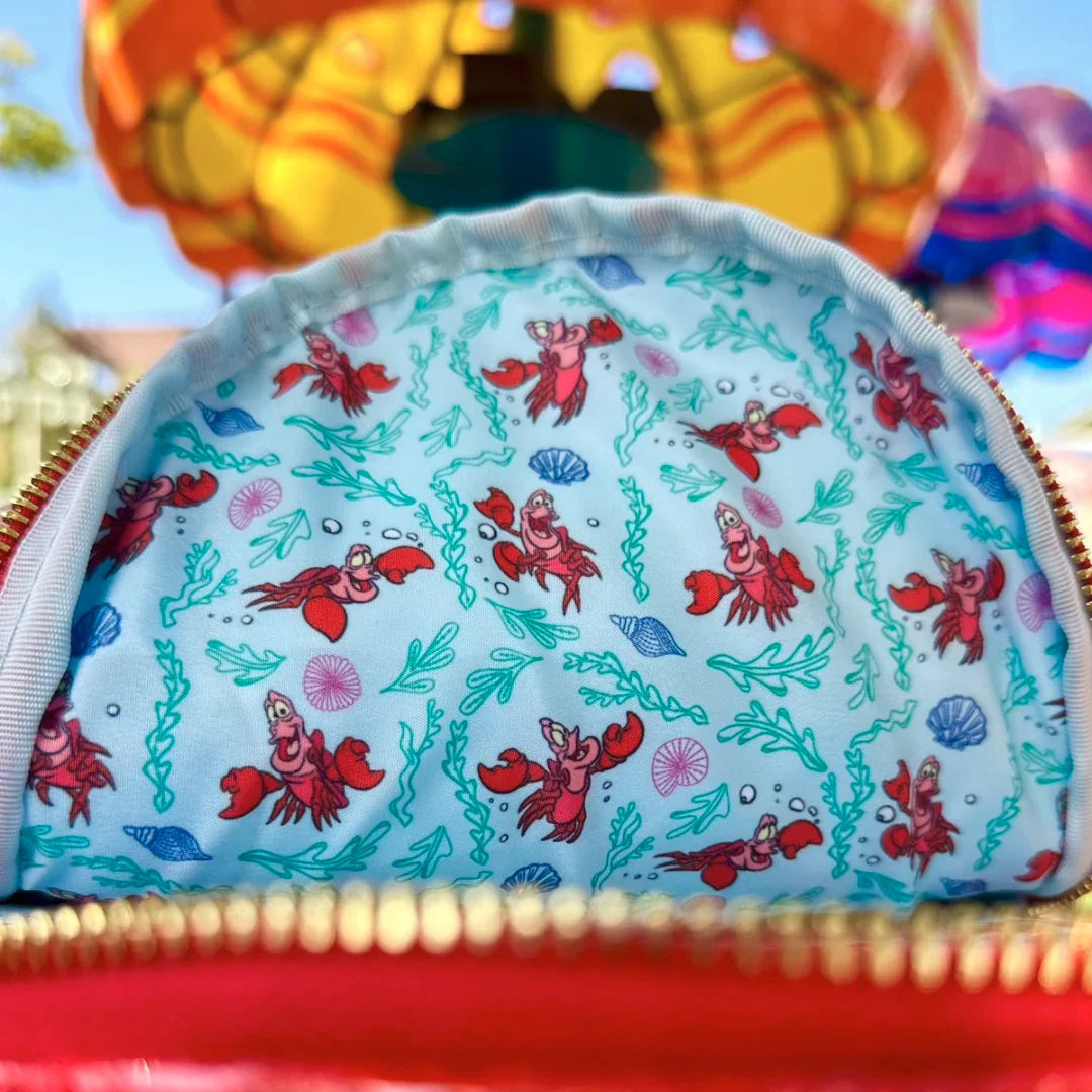 Small pouch with The Little Mermaid Sebastian Metallic design on a colorful background