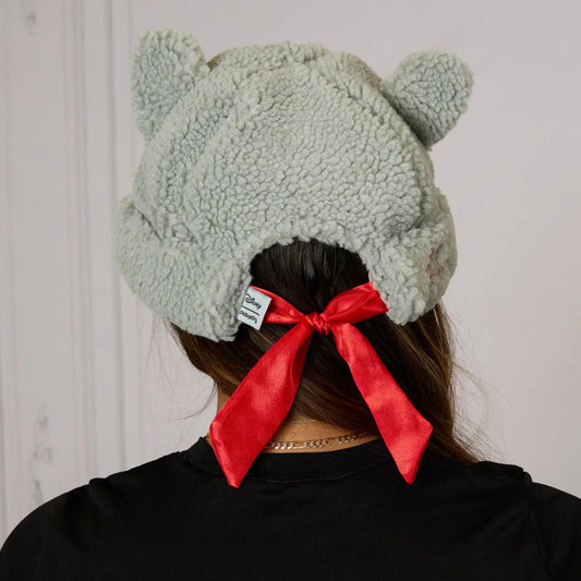 Person wearing a The Aristocats Berloiz Sherpa Beanie with animal ears and a red bow, against a white background.