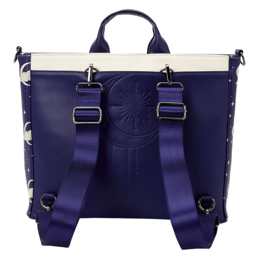 A structured tote bag in deep purple with a cream-colored top panel, featuring a large embossed sun face on the front, dual adjustable shoulder straps with silver buckles, and moon and star patterns printed along the side panels.