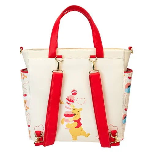 White handbag with red handles and strap featuring Winnie the Pooh on a white background