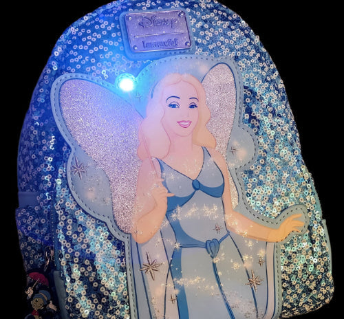 Backpack with the Blue Fairy, glowing wand, and Disney branding on a textured surface