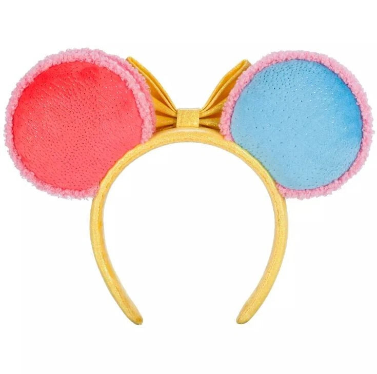 Colorful headband with pink and blue circular "macaron" ends and a yellow bow on a white background