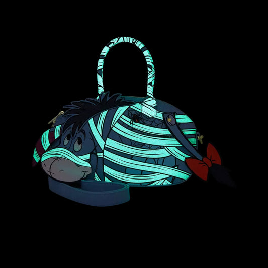 Mummy Eeyore character with glowing blue stripes on a black background
