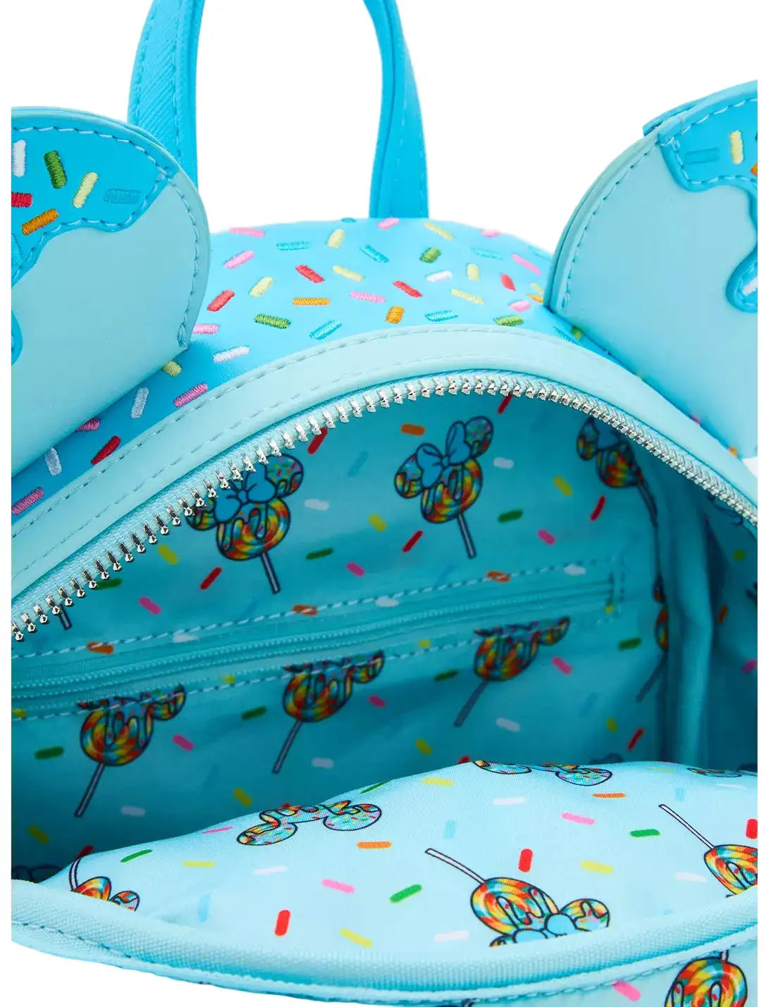 Inside Minnie Mouse Lollipop Blue Sprinkle Ears Backpack with character ears and lollipop design with lollipop themed design on a white background