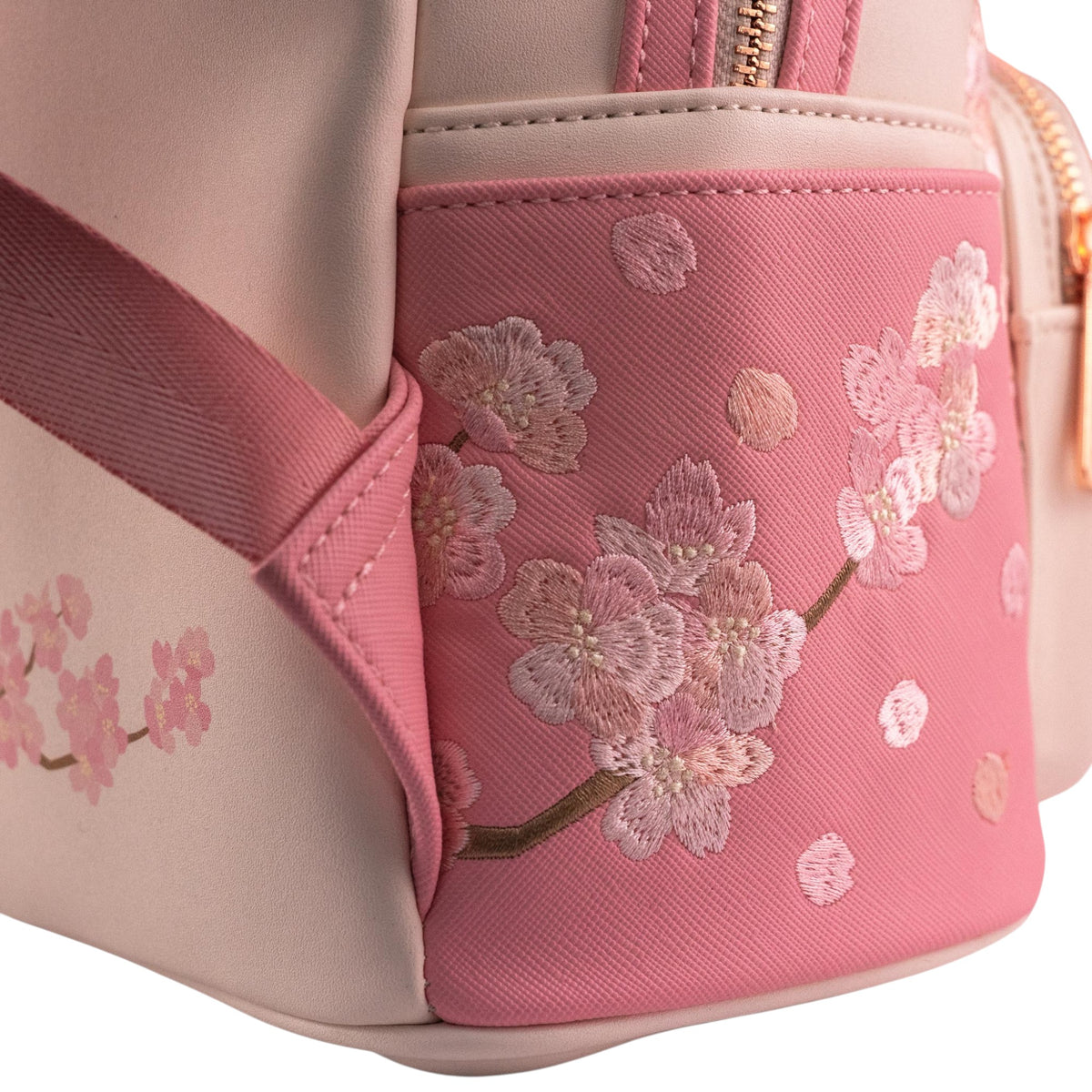 Close-up of bag's side with cherry blossom embroidery on a white background