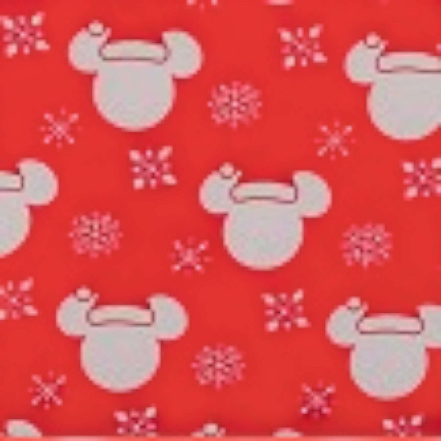 Pattern of mickey mouse character heads with snowflakes on a red background
