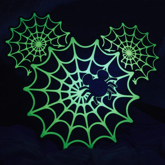 Glowing green Mickey Mouse Spiderweb design on a dark background
