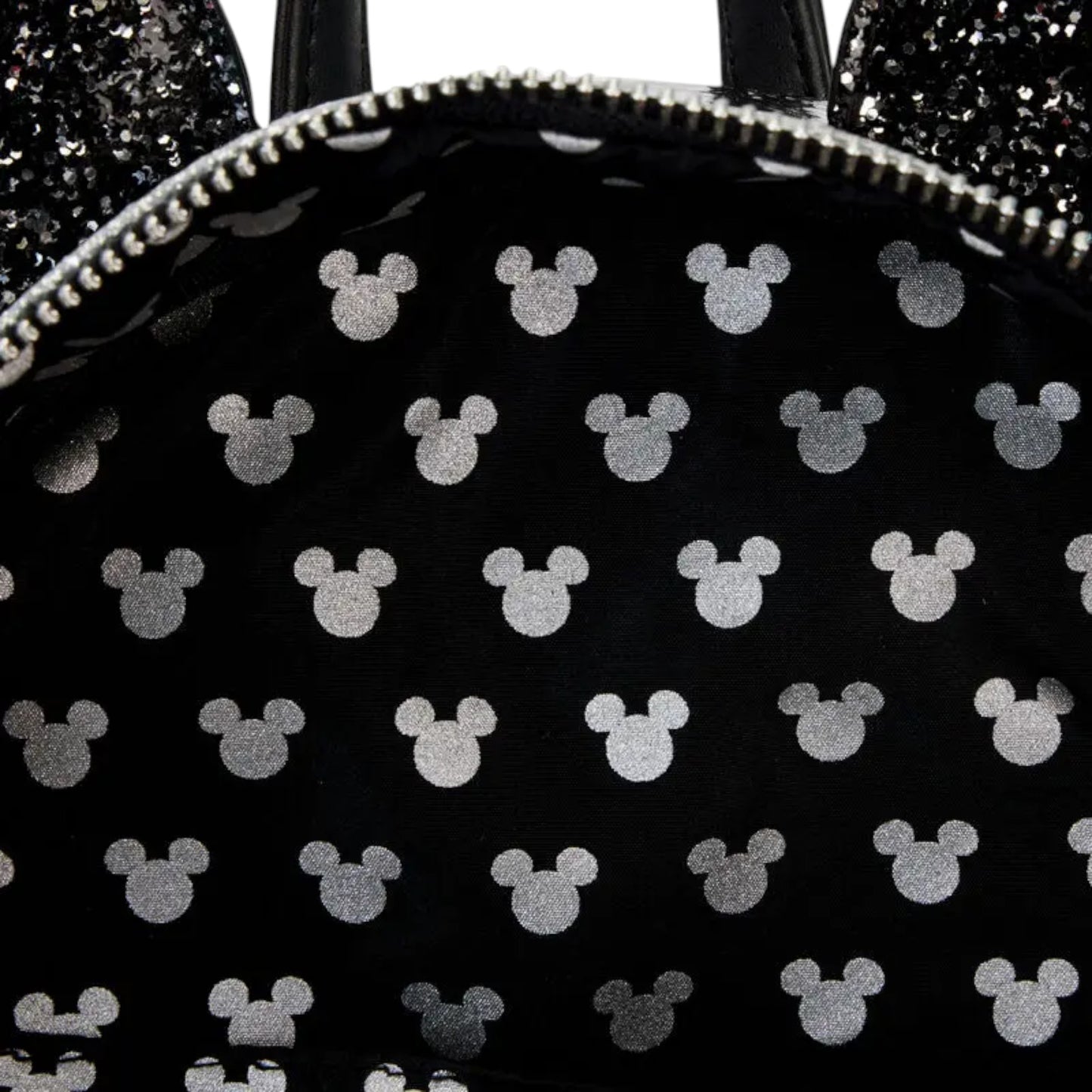 Black backpack with white Minnie Mouse icons on a black background