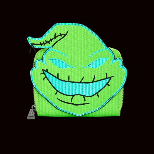 Oogie Boogie face glowing on a green wallet on a black background