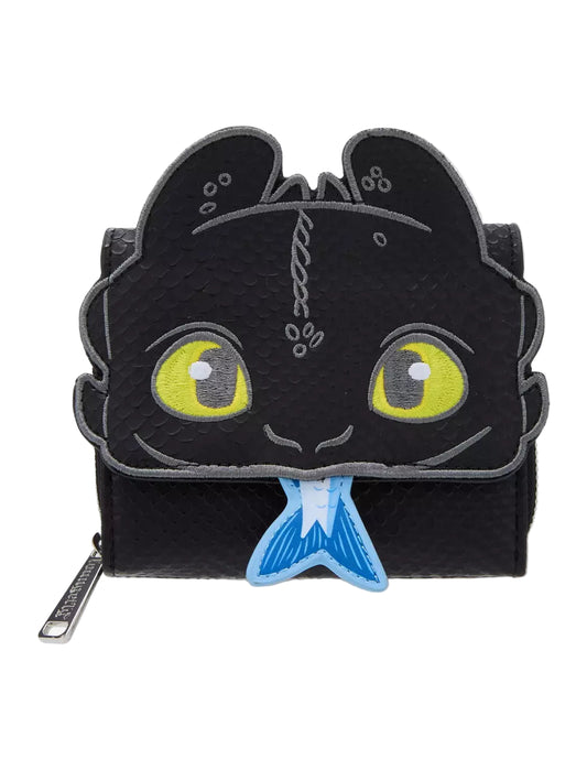 Front view Toothless Figural Wallet with yellow eyes holding a fish in his mouth on a white background