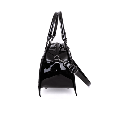 Side view of black bat shaped bag with crossbody strap attachd on a white background