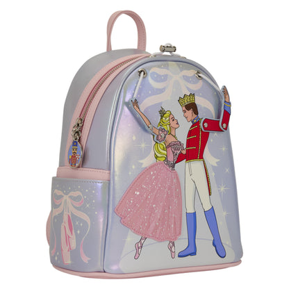 A metallic silver and pink backpack featuring a graphic of Cinderella and Prince Charming dancing, with a pink handle, pink zipper trim, and a ballet ribbon charm on the side pocket.