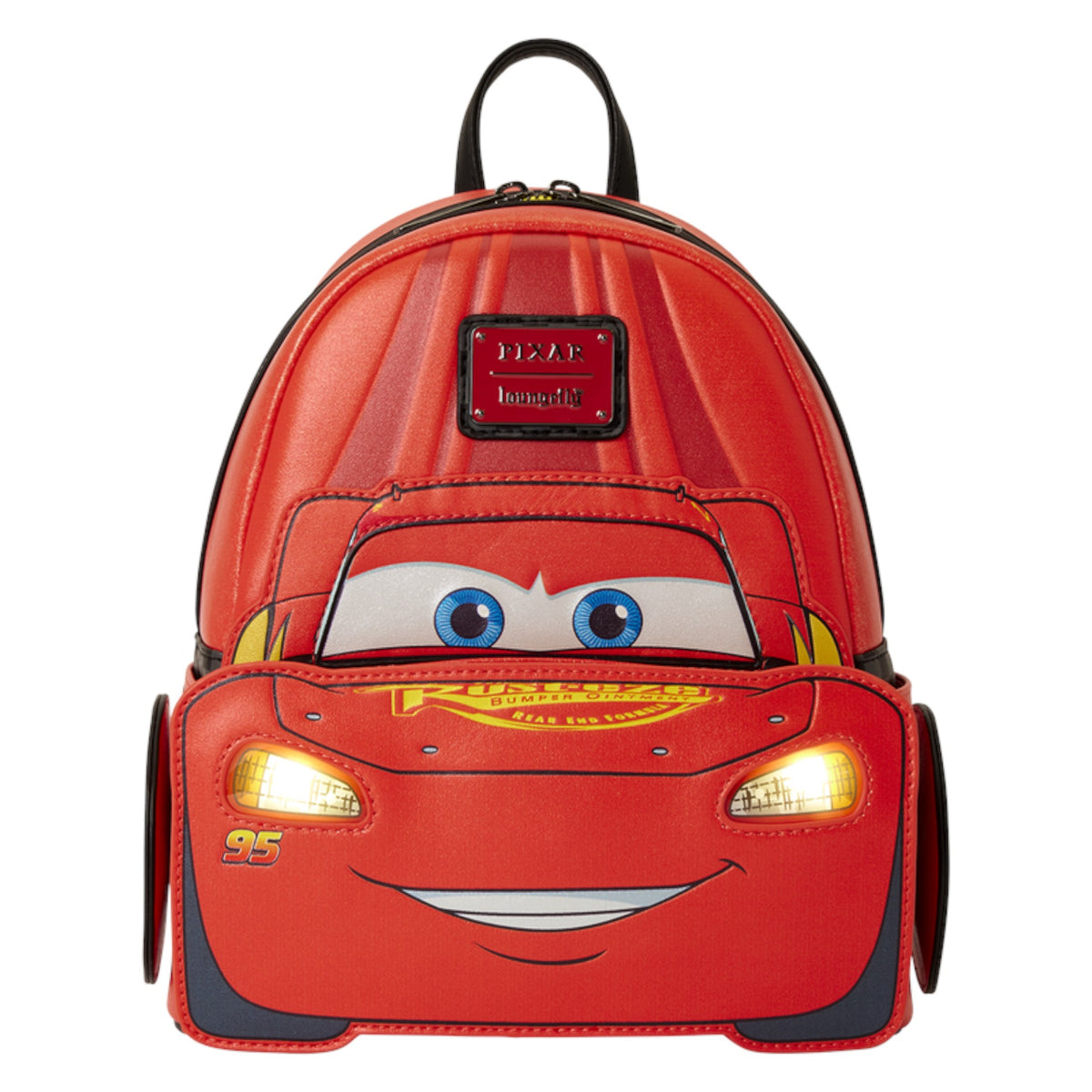 A red Lightning McQueen backpack shaped like a car face, with cartoon eyes, a smiling mouth, and illuminated headlights, shown on a plain white background.