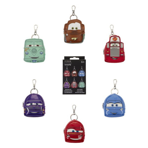 Six small character-shaped backpack keychains arranged around a black retail package on a white background. The characters appear to be from Pixar's Cars, including a mint green van, brown truck, red fire truck, purple car, blue car, and red car, each with a silver key ring.