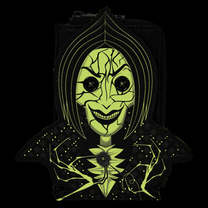 A black hooded bag or pouch featuring a stylized neon yellow-green face graphic with cracked facial features, large black eyes, and a wide grin, shown against a solid black background.