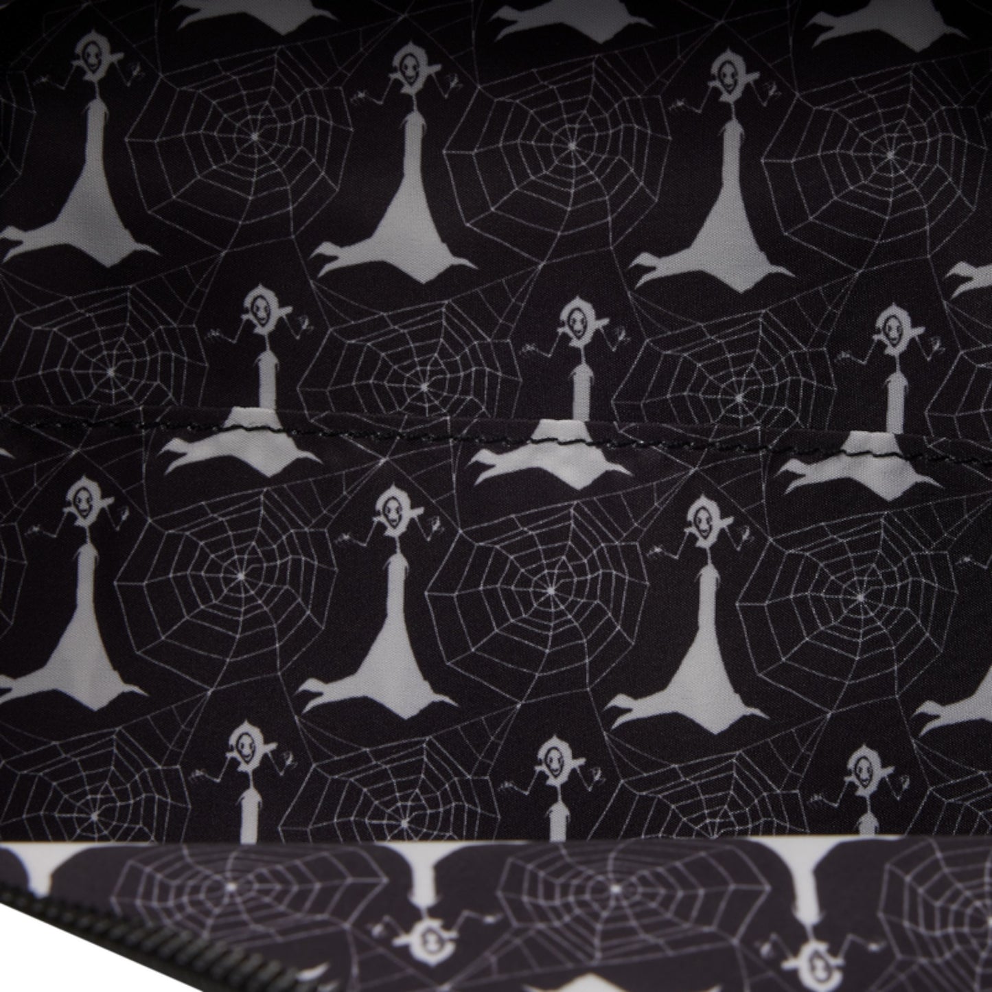 Black fabric with a repeating white pattern of skeleton figures and spiderwebs, shown folded to display the pattern.