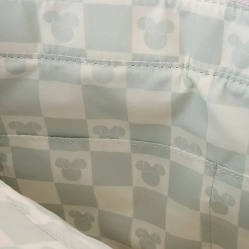 Checkered fabric with a pattern of small minnie mouse heads on a light background.