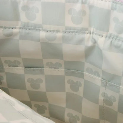 Checkered fabric with a pattern of small minnie mouse heads on a light background.