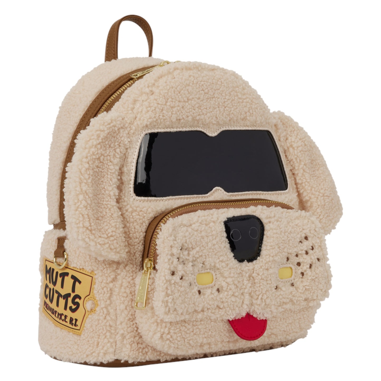 A dog-shaped teddy fleece backpack in cream beige, featuring a black faux-leather face patch, gold zippers, and a 'Mutt Cutts' patch on the side pocket, shown on a plain white background.