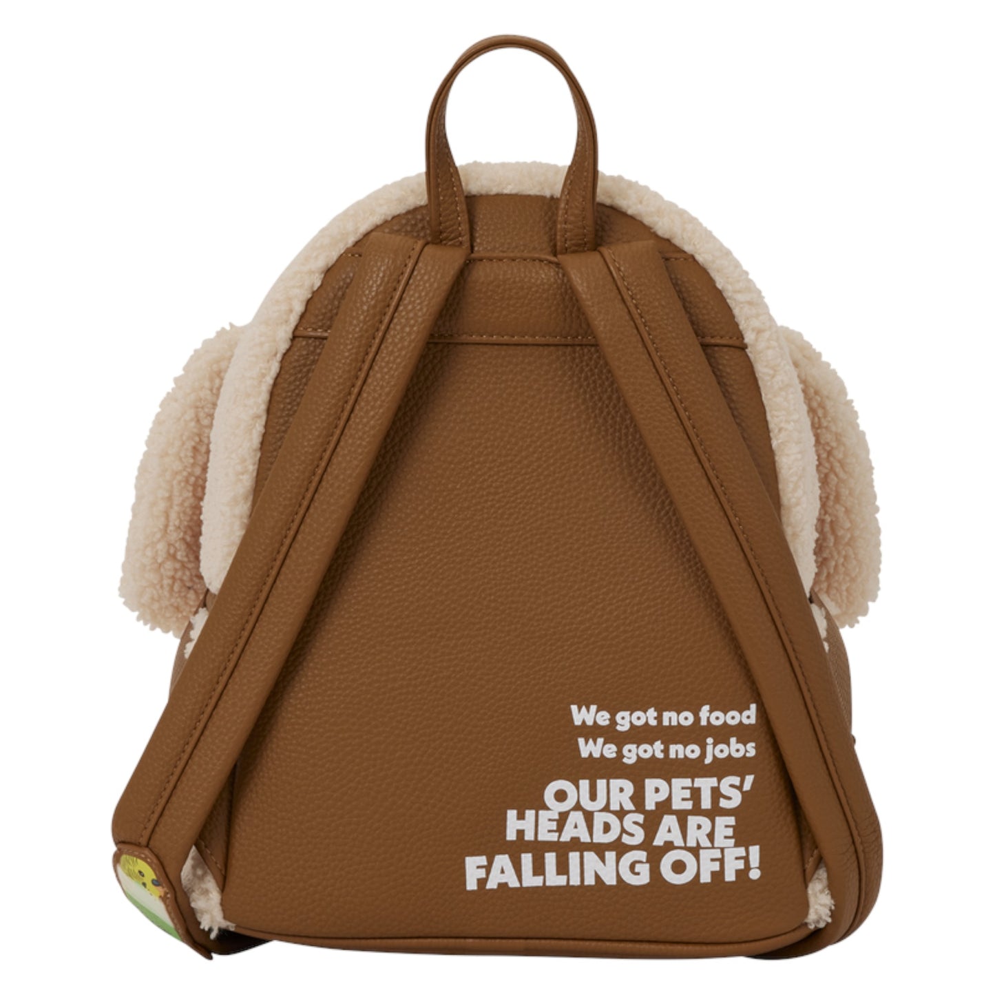 A brown faux-leather backpack with a cream sherpa lining and floppy side tabs, featuring white text on the back that reads 'We got no food We got no jobs OUR PETS' HEADS ARE FALLING OFF!'.