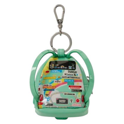 A mint green backpack-shaped coin purse keychain featuring a colorful collage of road safety stickers and a silver metal clasp on a white background.