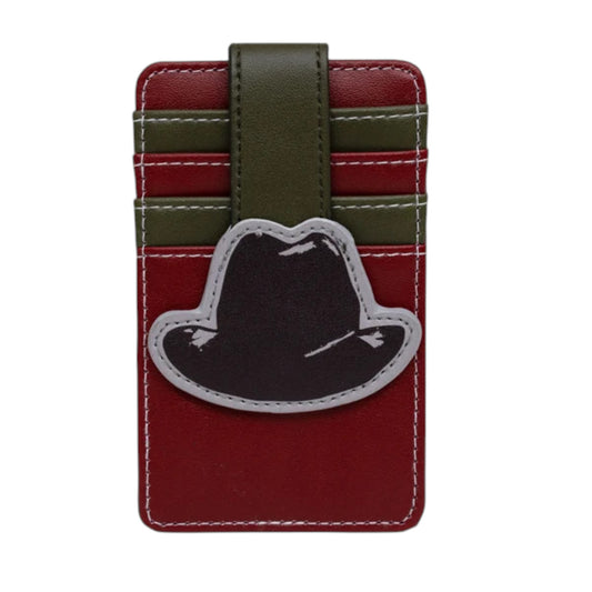 A red faux leather card holder wallet featuring an olive green strap, horizontal green stripe accents, white stitching, and a black hat-shaped patch with a gray border on the front.