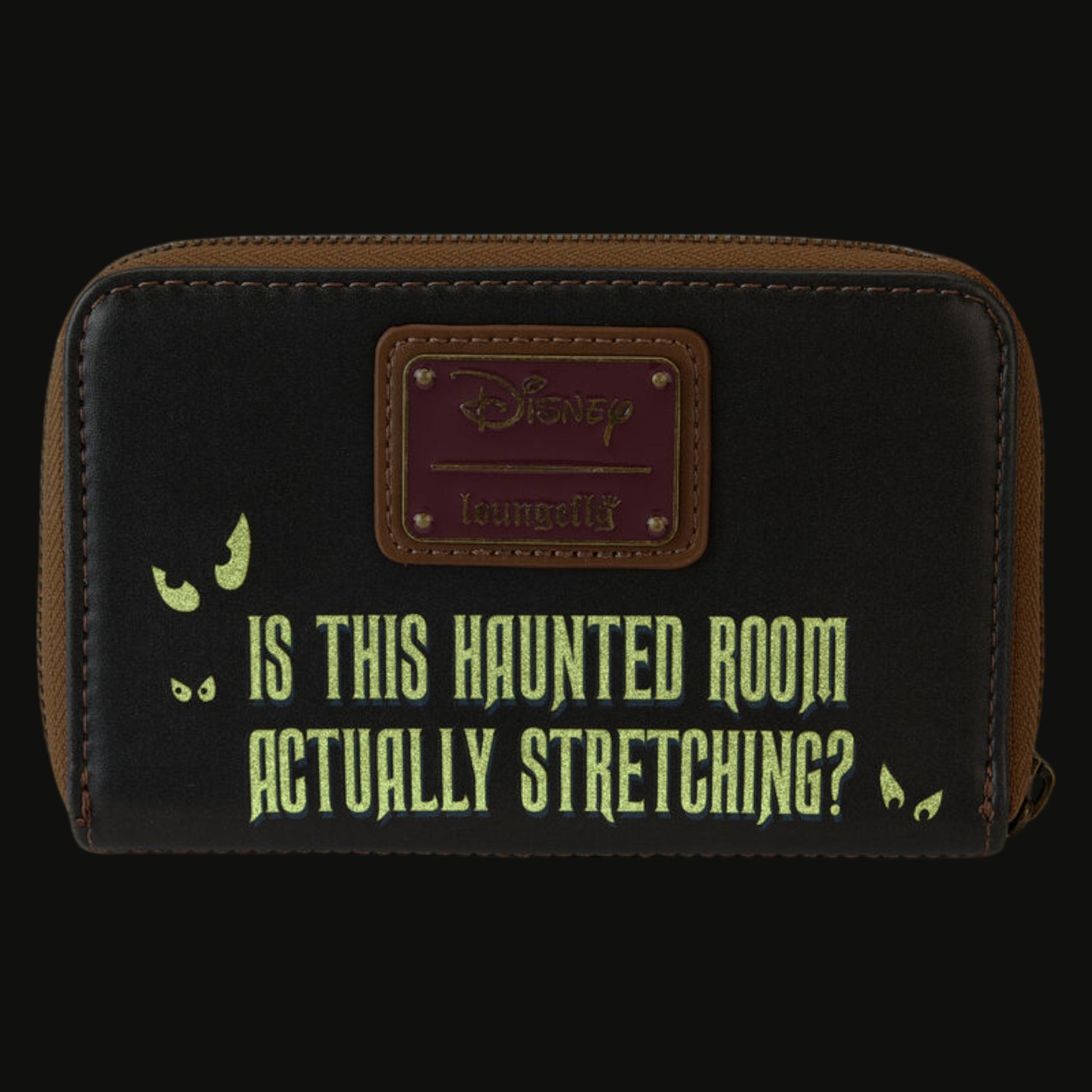 Glowing back of Loungefly Haunted Mansion Stretching Room Portraits wallet with 'Is This Haunted Room Actually Stretching?' yellow text and a Disney Loungefly logo on a white background