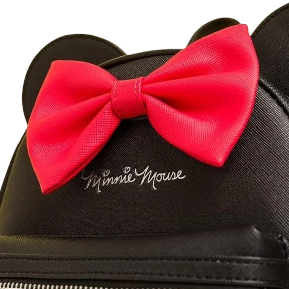 Black backpack with a large red bow and 'Minnie Mouse' branding.