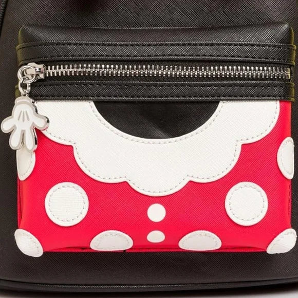 Polka dot pouch with a black zipper on a black background